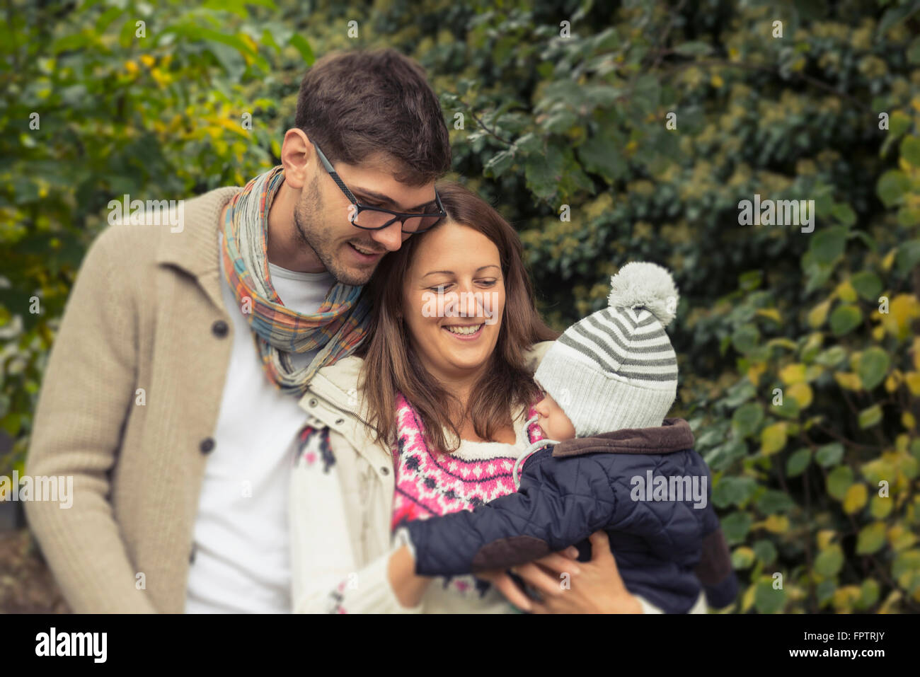 Father and mother standing with baby, Bavaria, Germany Stock Photo