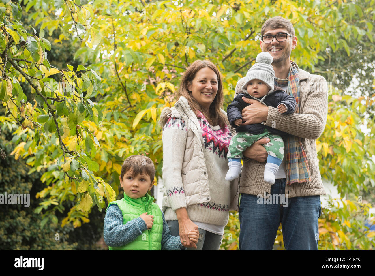 Portrait of a nuclear family standing in an organic farm and smiling, Bavaria, Germany Stock Photo
