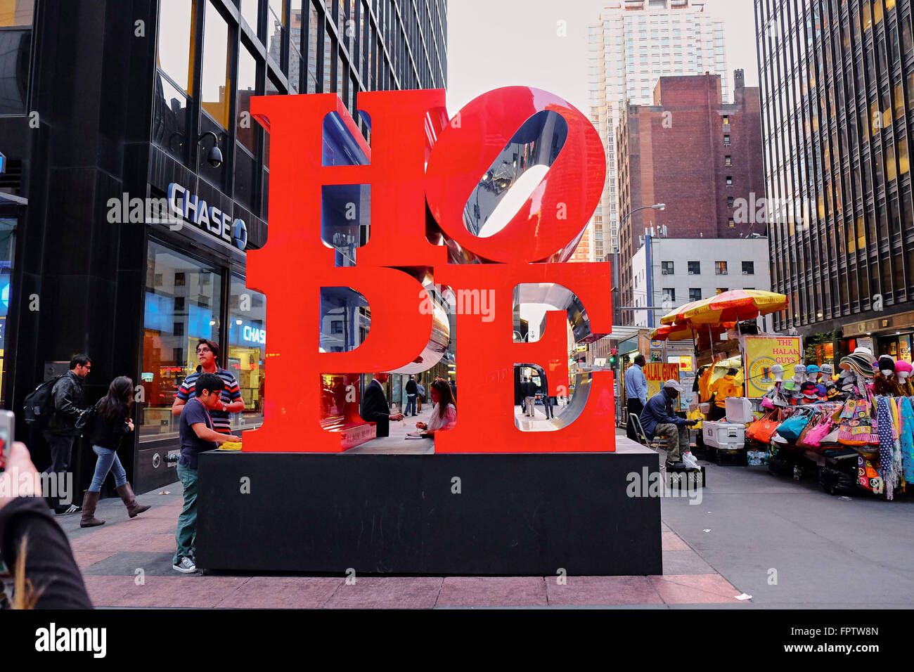 NEW YORK CITY - OCTOBER 9, 2014: The Hope sculpture of Robert Indiana standing on the corner of 7th and 53rd in New York City Stock Photo