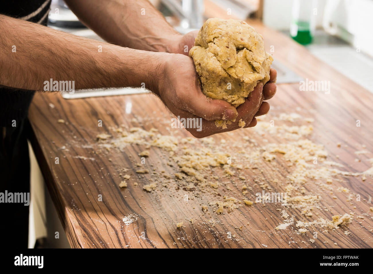 Close-up of man holding dough for preparing cookies, Munich, Bavaria, Germany Stock Photo