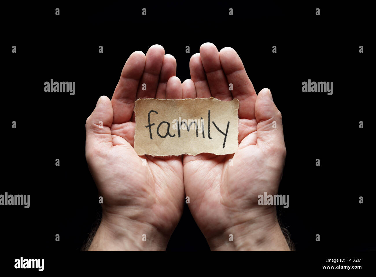 Family with the protection of cupped hands, concept for love, health, security and care Stock Photo