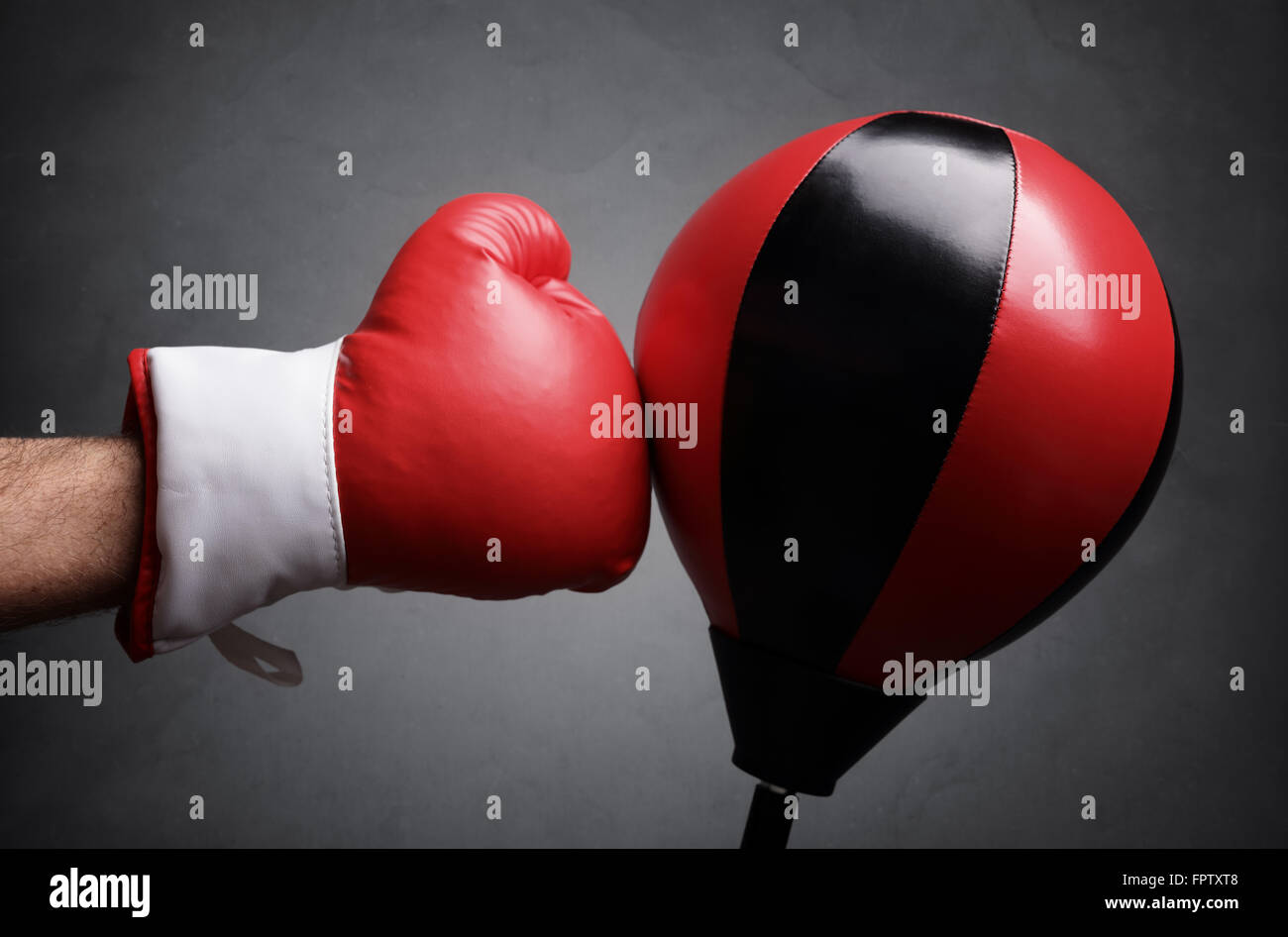 Punching a red punch bag concept for competition, challenge, conflict or leadership in business Stock Photo