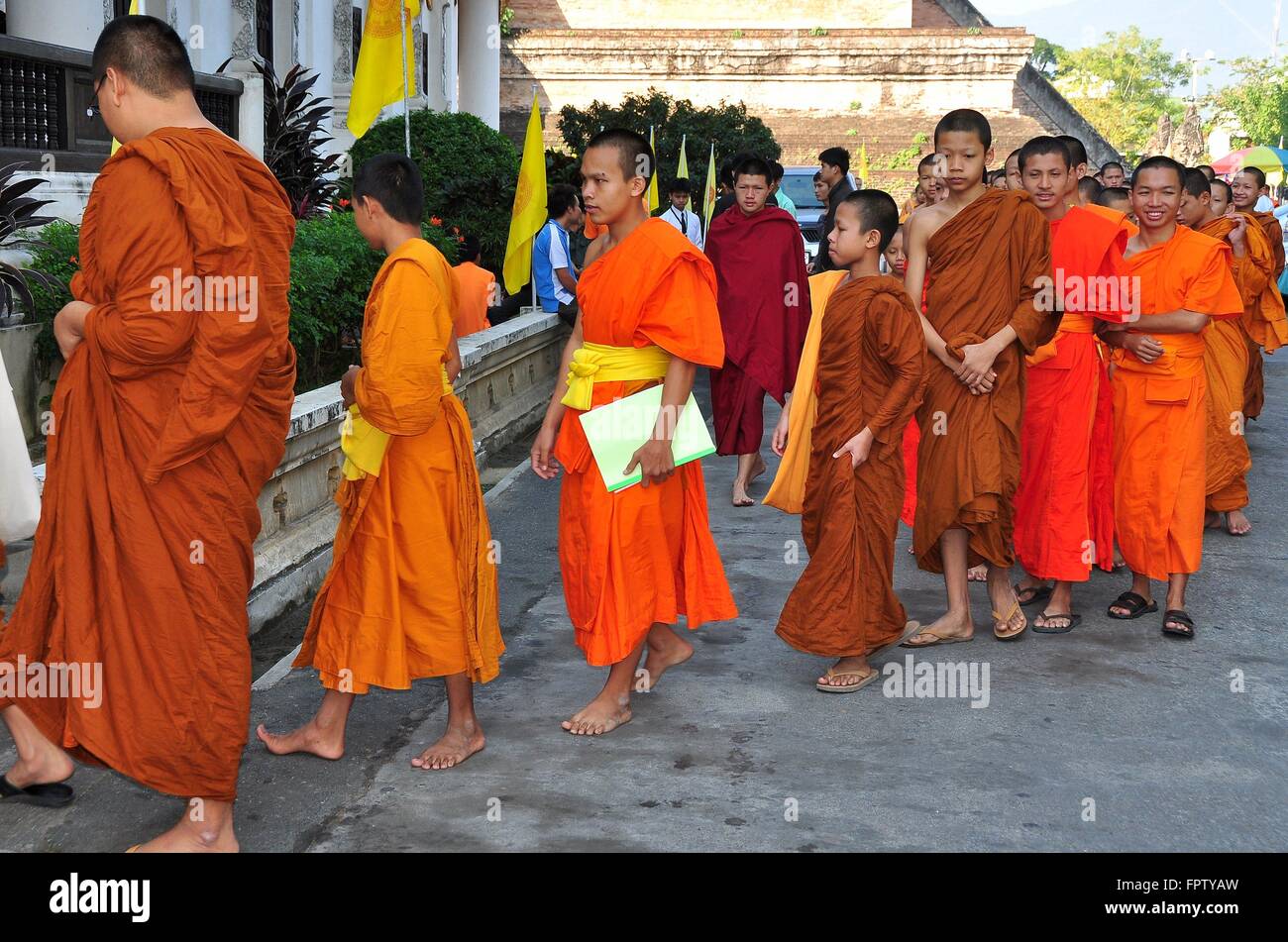 Chiang Mai, Thailand Barefoot novitiate teenage monks wearing orange