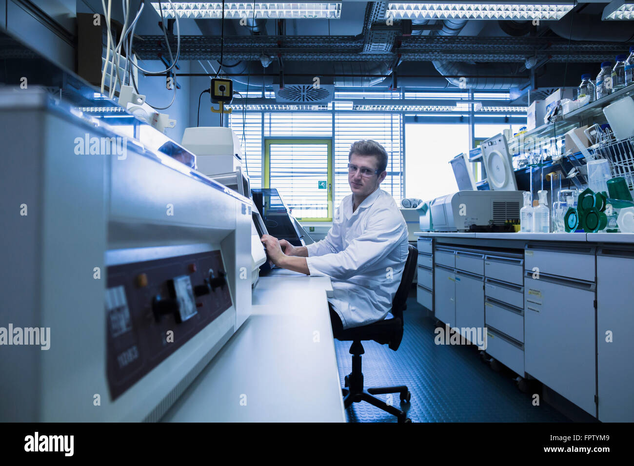 Young male scientist working in a pharmacy laboratory, Freiburg Im ...