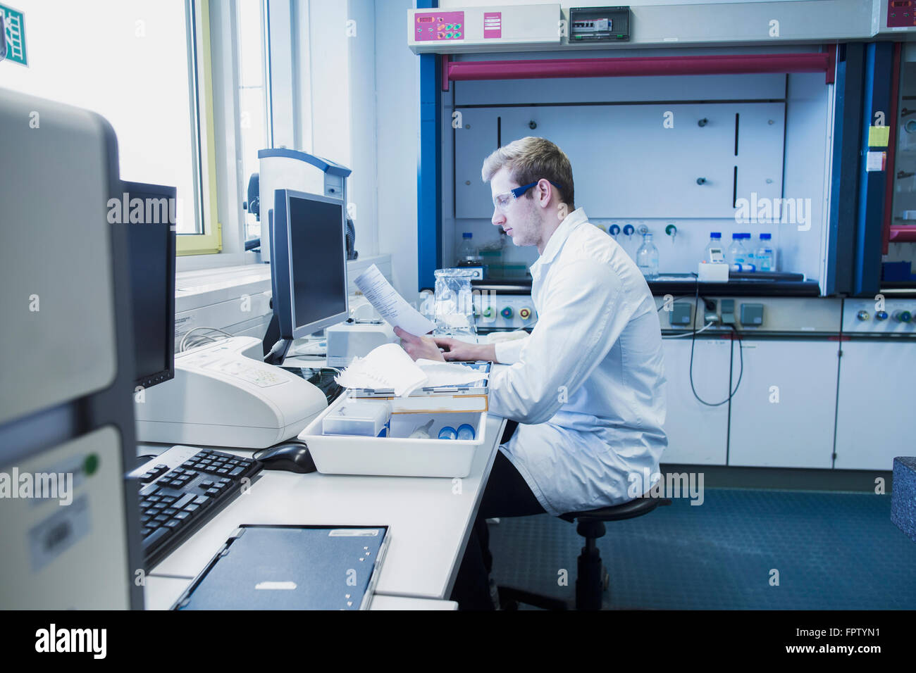 Young male scientist working in a pharmacy laboratory, Freiburg Im ...