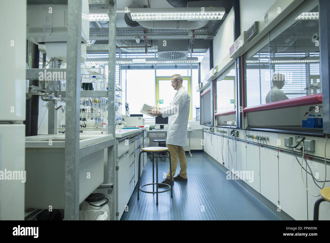 Young male scientist working in a pharmacy laboratory, Freiburg Im ...