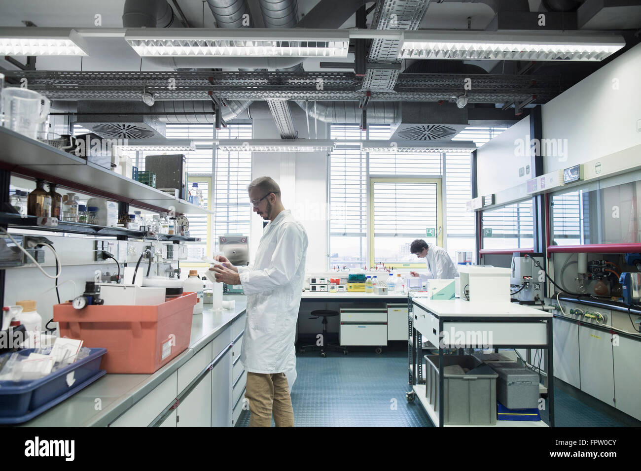 Male scientists working in a pharmacy laboratory, Freiburg Im Breisgau ...