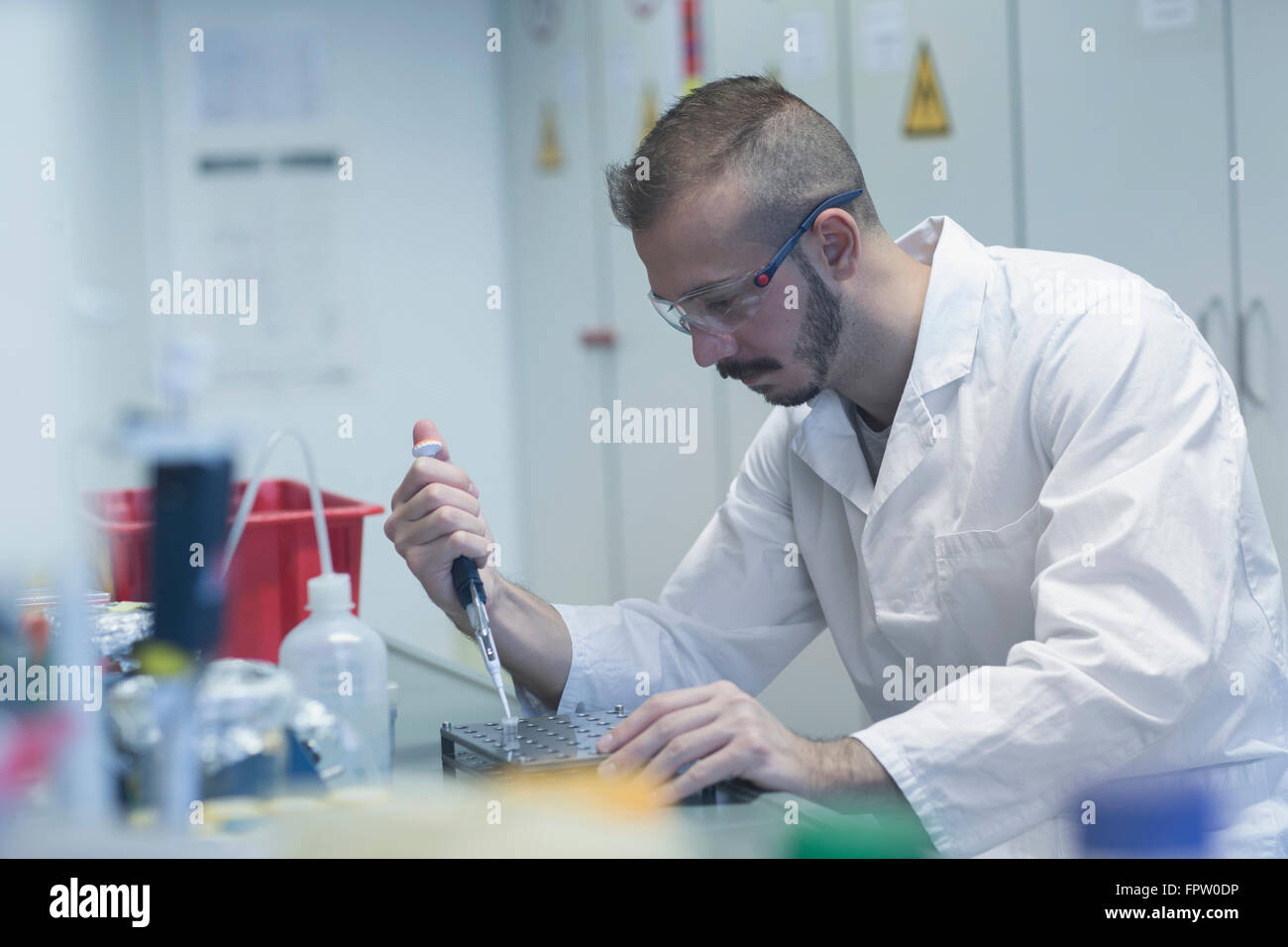 Scientist pipetting sample in test tube, Freiburg Im Breisgau, Baden
