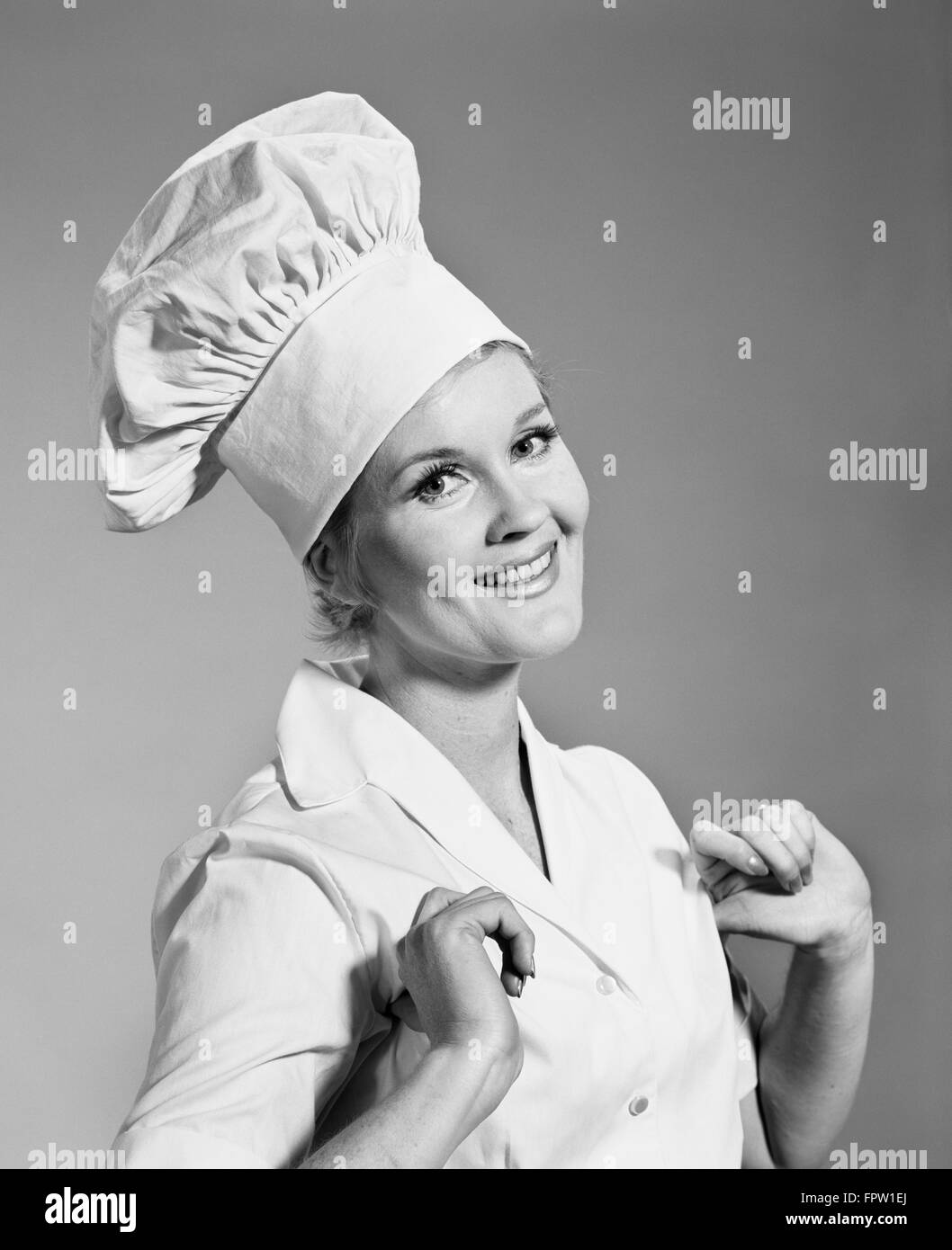1960s SMILING PROUD WOMAN WEARING CHEF'S CHEFS HAT TOQUE LOOKING AT CAMERA Stock Photo
