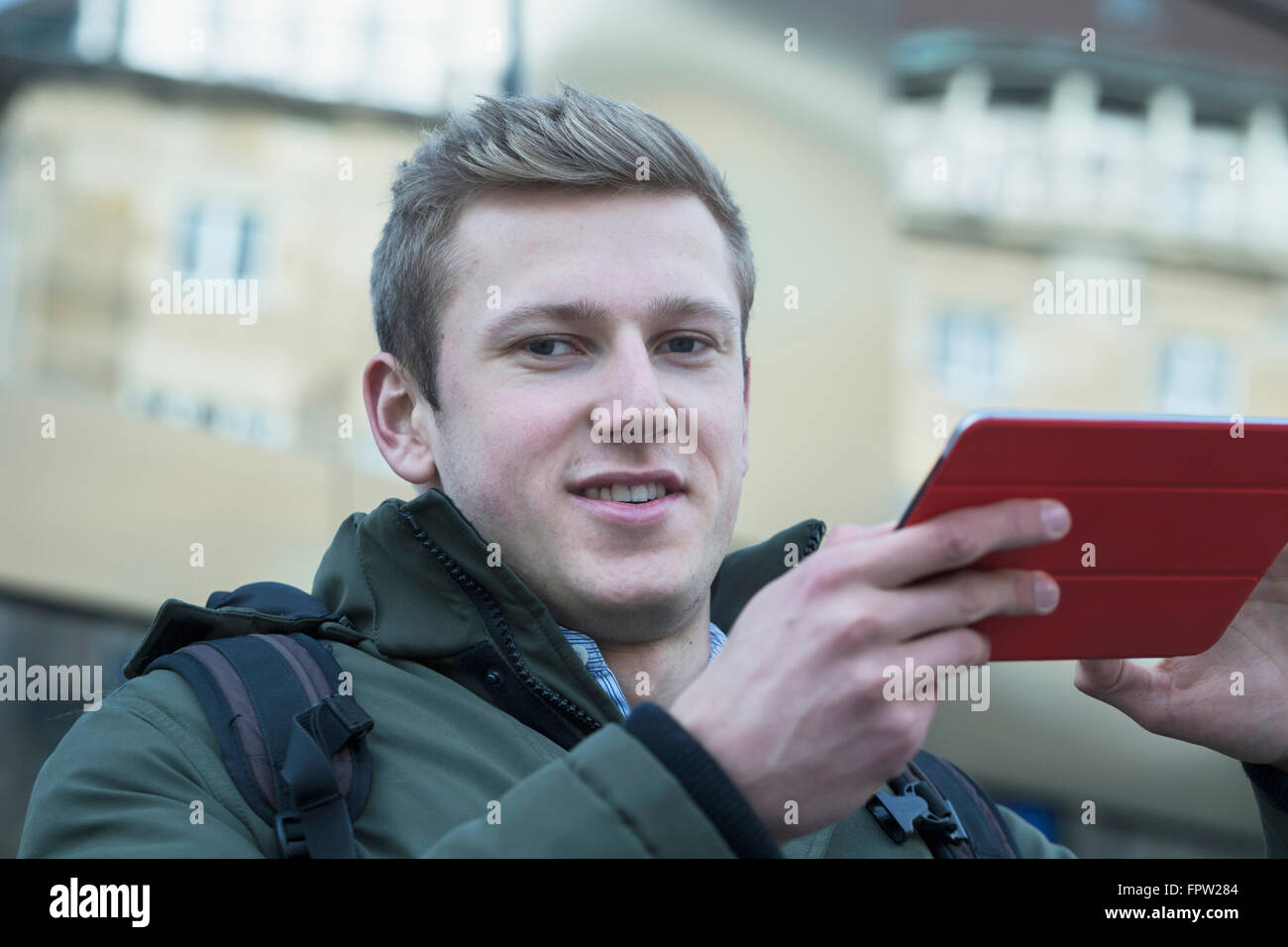 Portrait of a young student using digital tablet, Freiburg im Breisgau, Baden-Württemberg, Germany Stock Photo