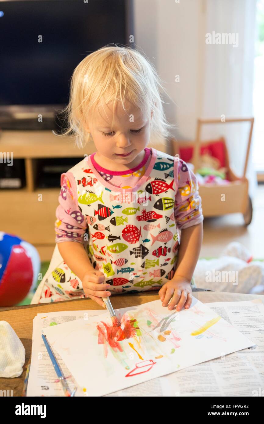 Toddler painting with watercolours Stock Photo