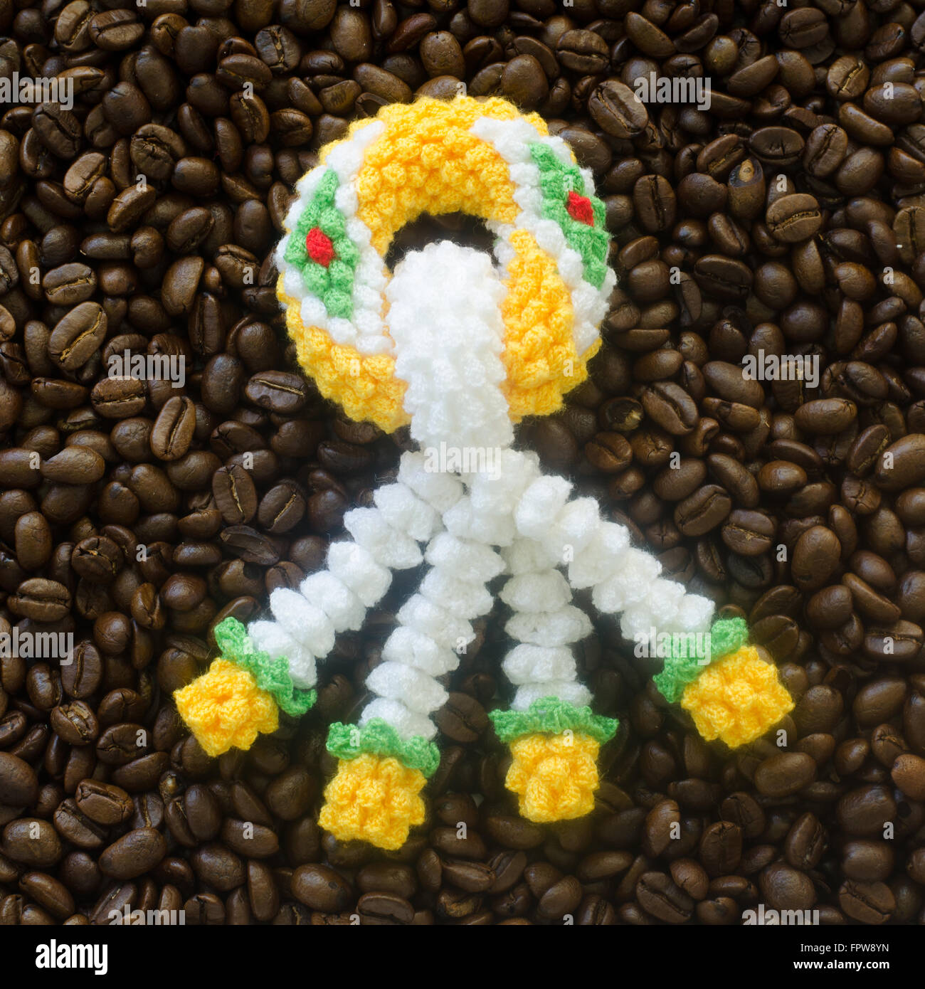 garland knitting on coffee bean background Stock Photo