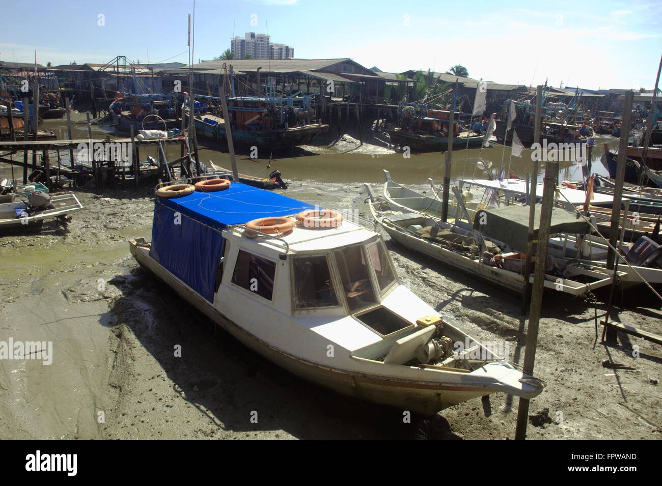 Fishing boats in fishing village during low tide Stock Photo - Alamy
