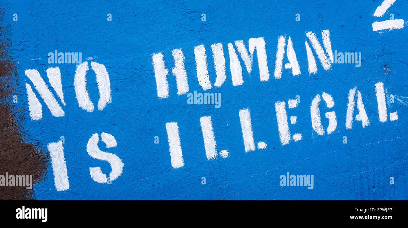 No human is illegal stenciled graffiti in West Belfast Stock Photo
