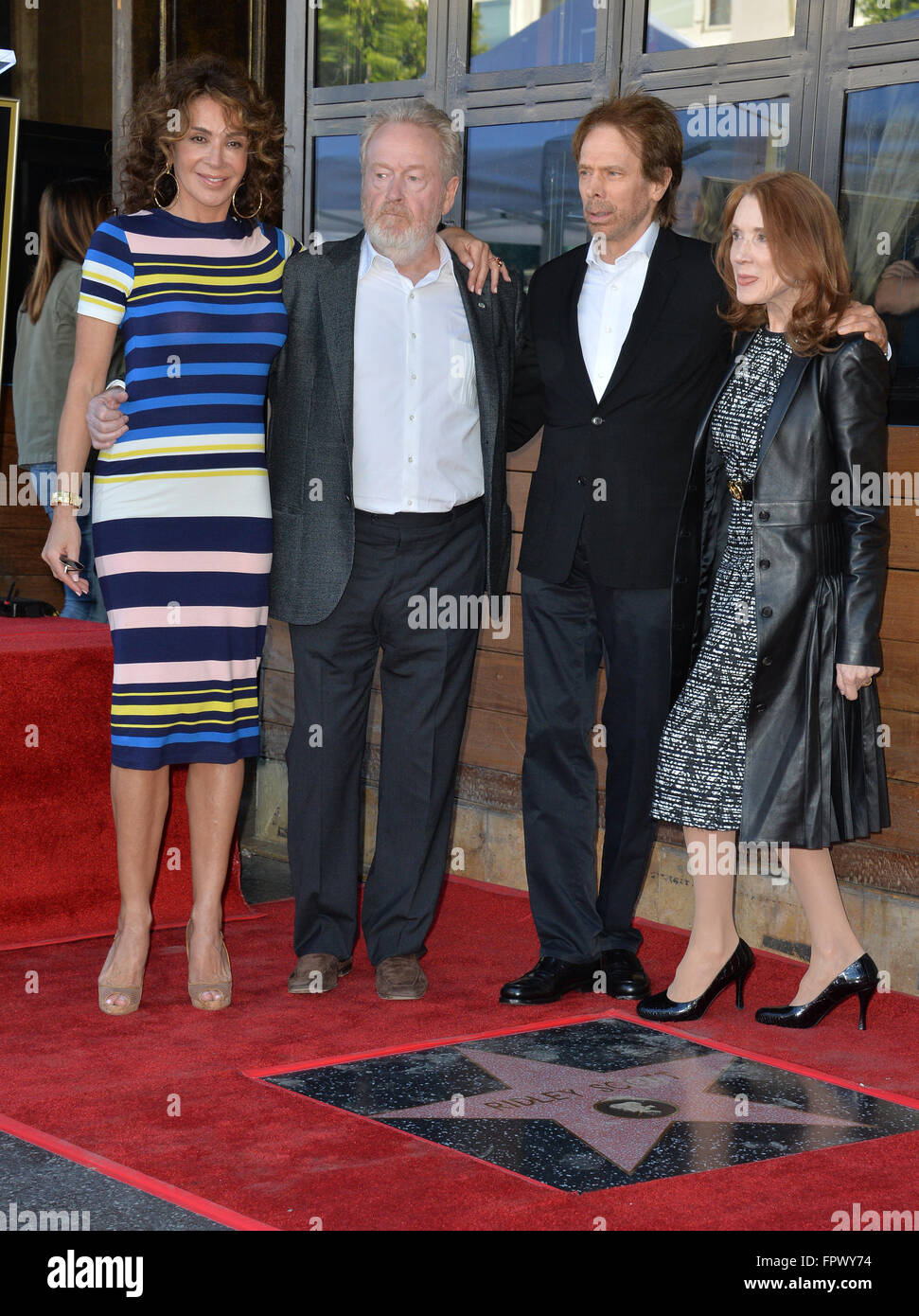 LOS ANGELES, CA - NOVEMBER 5, 2015: Director Ridley Scott & partner Giannina Facio with producer Jerry Bruckheimer & wife Linda on Hollywood Boulevard where he was honored with the 2,564th star on the Hollywood Walk of Fame. Stock Photo