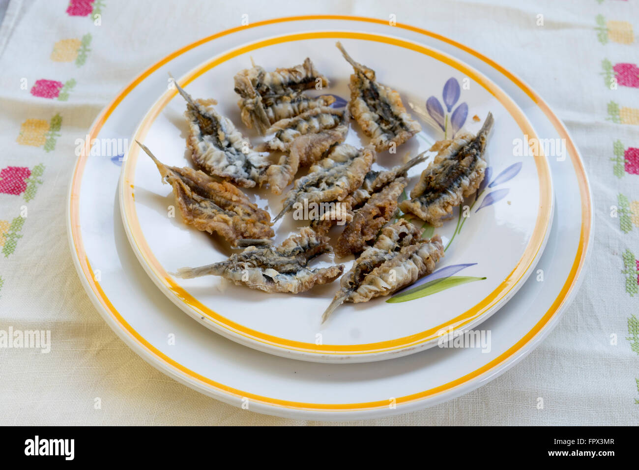 fresh anchovies of the mediterranean sea floured and fried and served