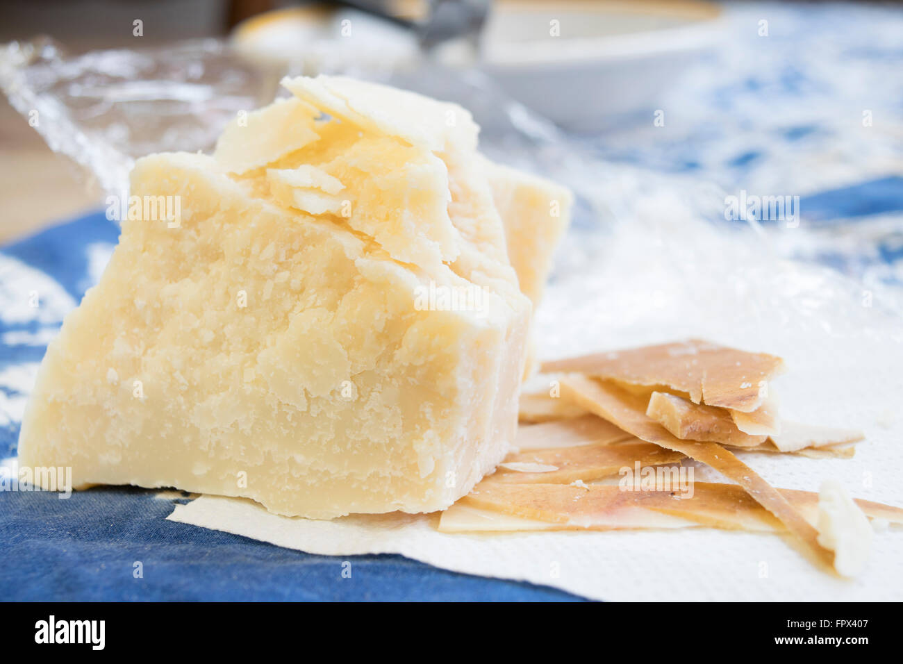 chunks and rind of parmigiano cheese with near a big piece of heart Stock Photo
