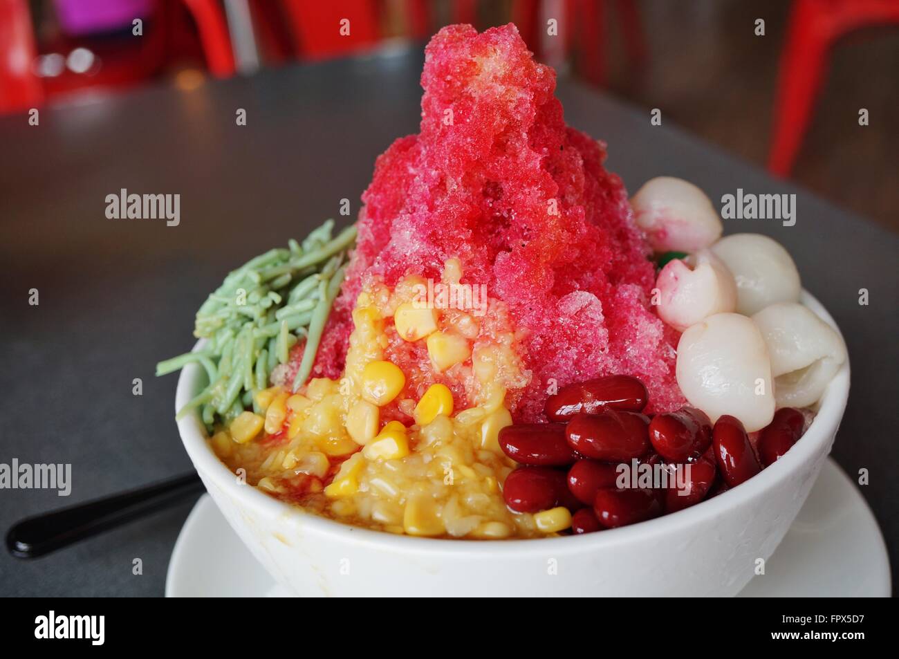 Ais Kacang (ABC), a colorful Malaysian dessert made of shaved ice, beans and colored jelly Stock Photo