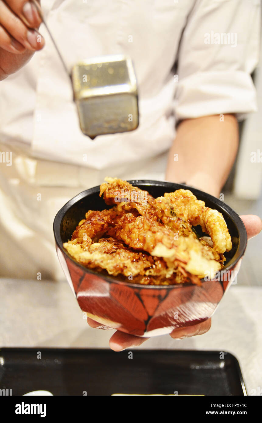 Chef pouring soy sauce on Tempura rice bowl Stock Photo Alamy