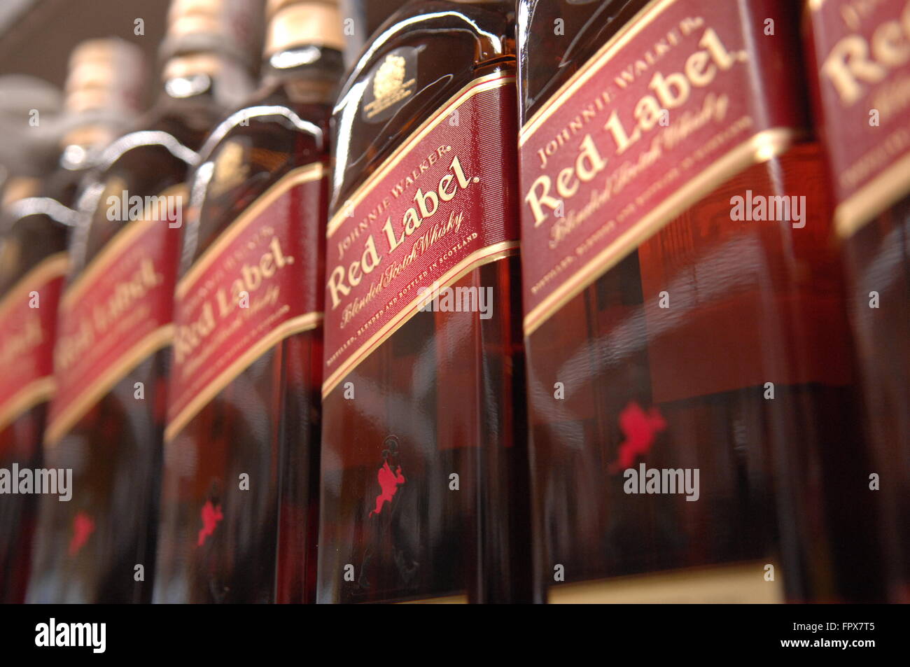 Johnnie Walker Scotch Whiskey Red Label owned by Diageo close up on shelves in Carrefour Supermarket,Malaga Spain. Stock Photo