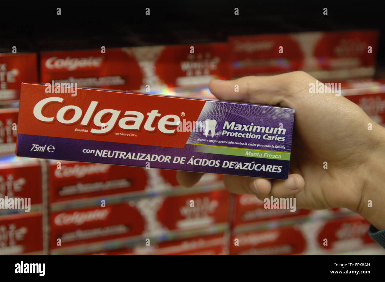 Colgate Toothpaste being viewed by customer in a Carrefour Supermarket