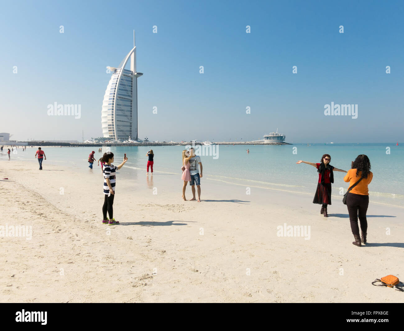 Tourists Taking Photos And Selfies On Jumeirah Beach With Luxury Burj Al Arab Hotel In Background Dubai United Arab Emirates Stock Photo Alamy