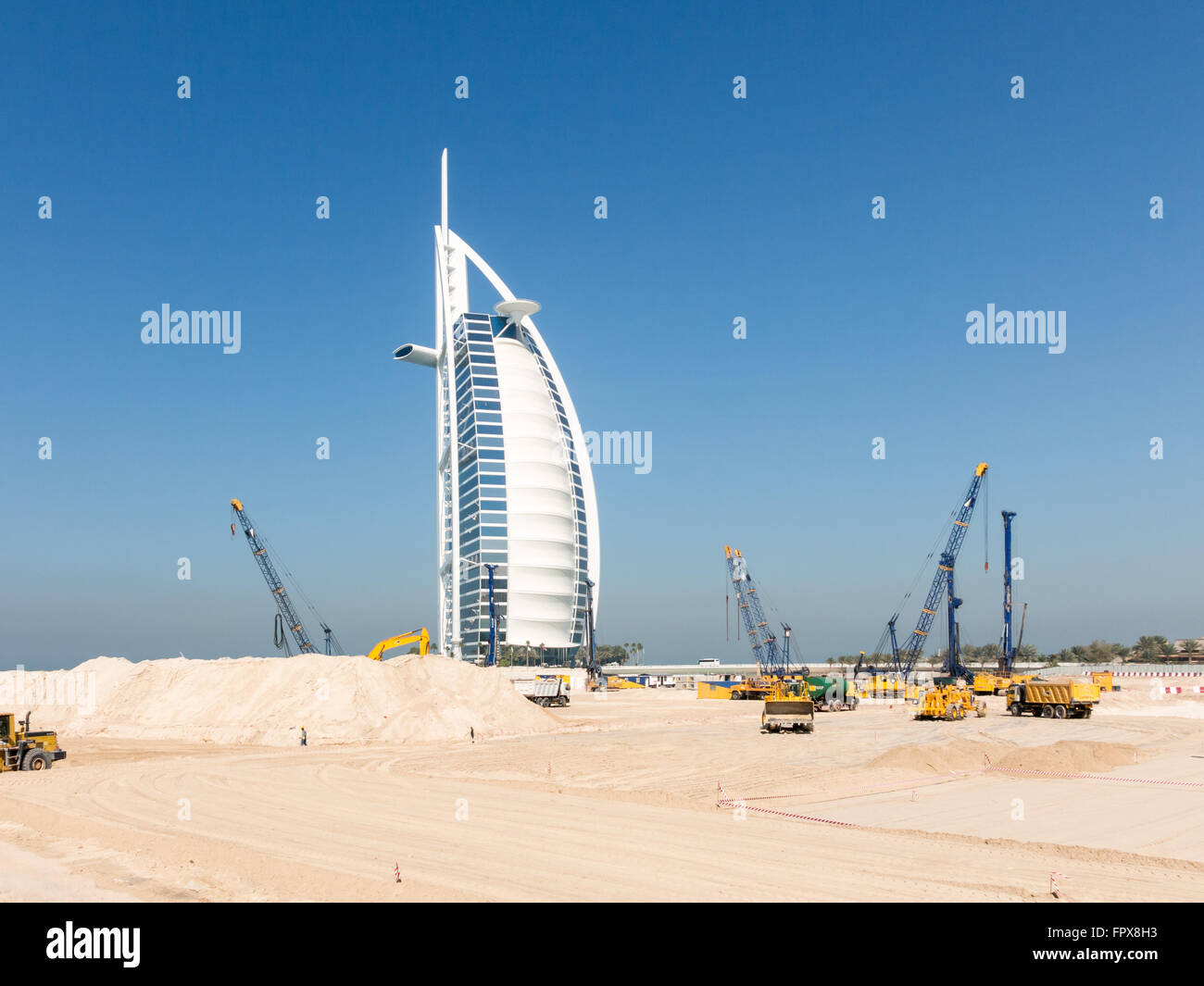 Cranes and work in progress on construction site near Burj al Arab Hotel, Jumeirah Beach in the city of Dubai, United Arab Emira Stock Photo