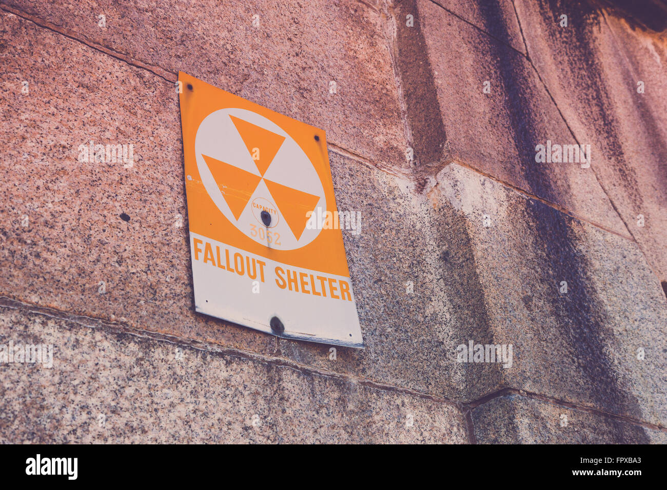 A old fallout shelter sign on the side of an old military fort. Stock Photo