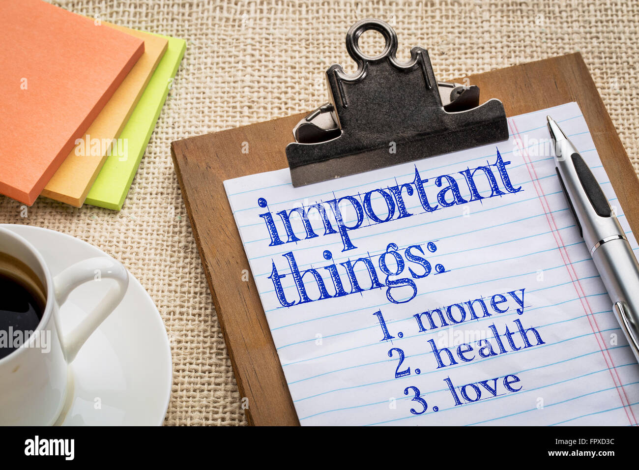 important things list, money, health and love, on clipboard with a pen ...