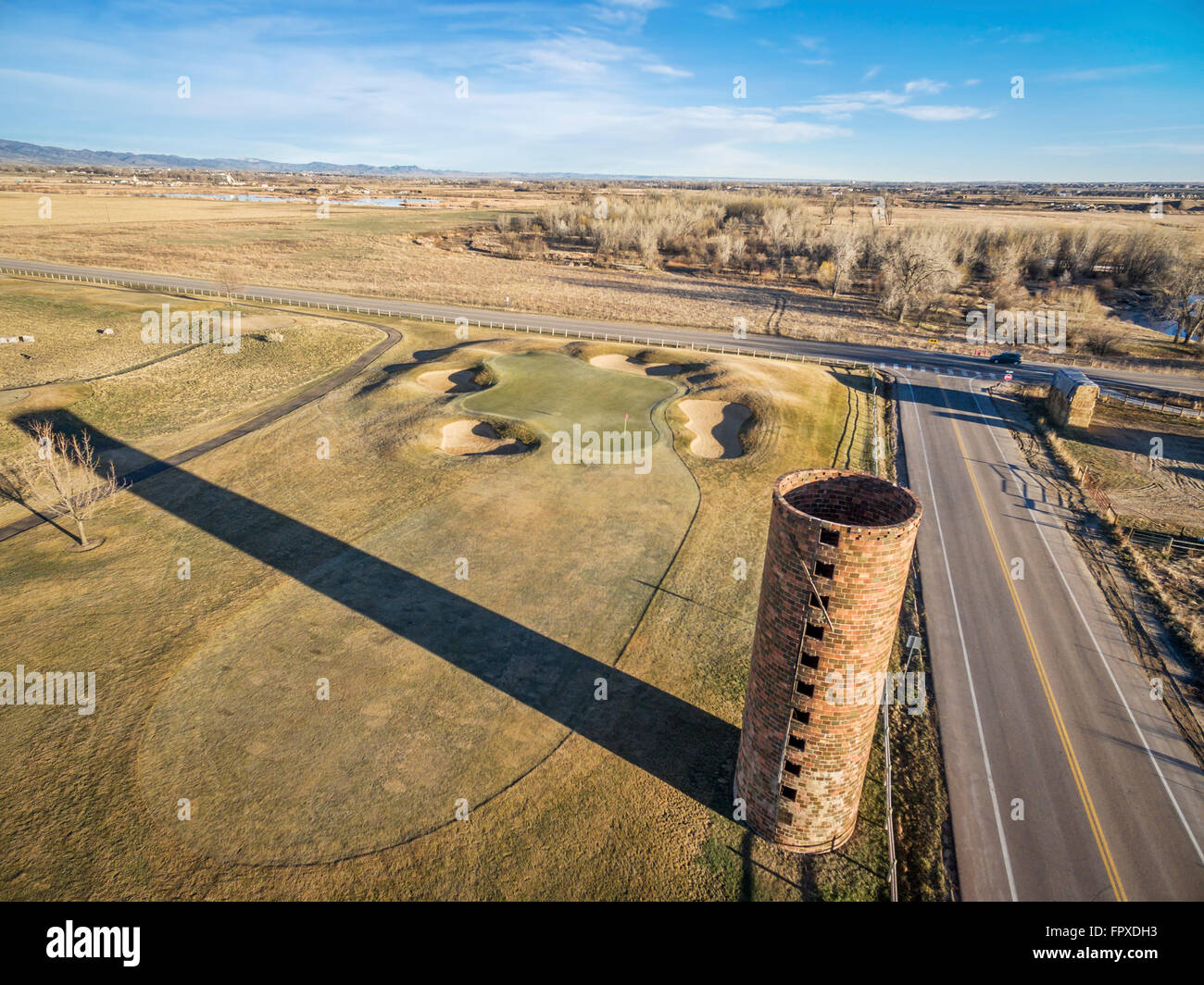 farm silo and golf course along Cache la Poudre River in Colorado, aerial view in early springtime Stock Photo