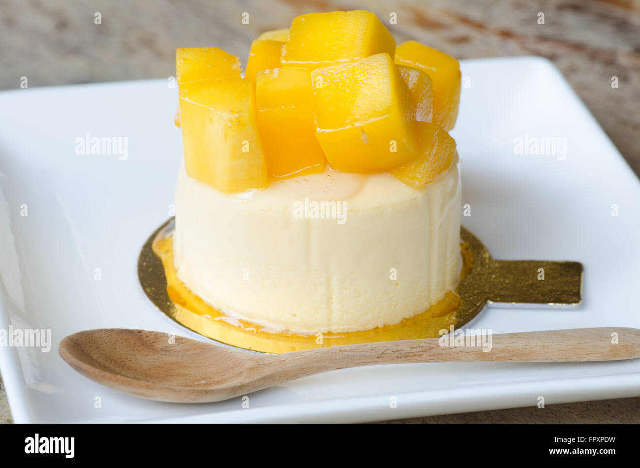 mango cheesecake on white plate Stock Photo
