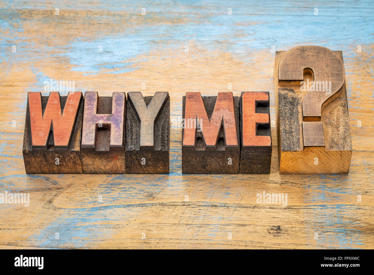 Why me question  - text in vintage letterpress wood type blocks stained by color inks Stock Photo