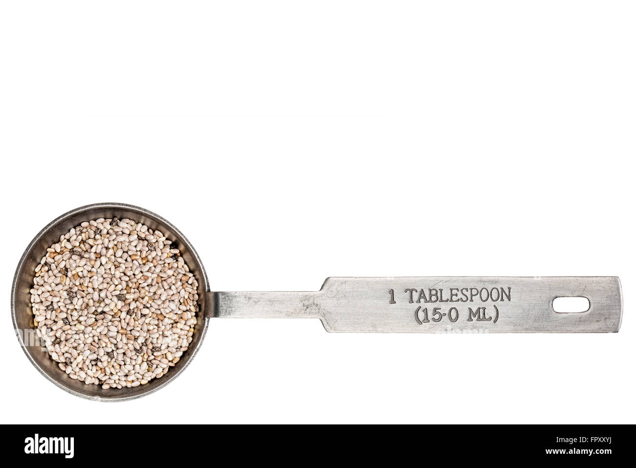 white chia seeds  in a metal measuring tablespoon isolated on white Stock Photo