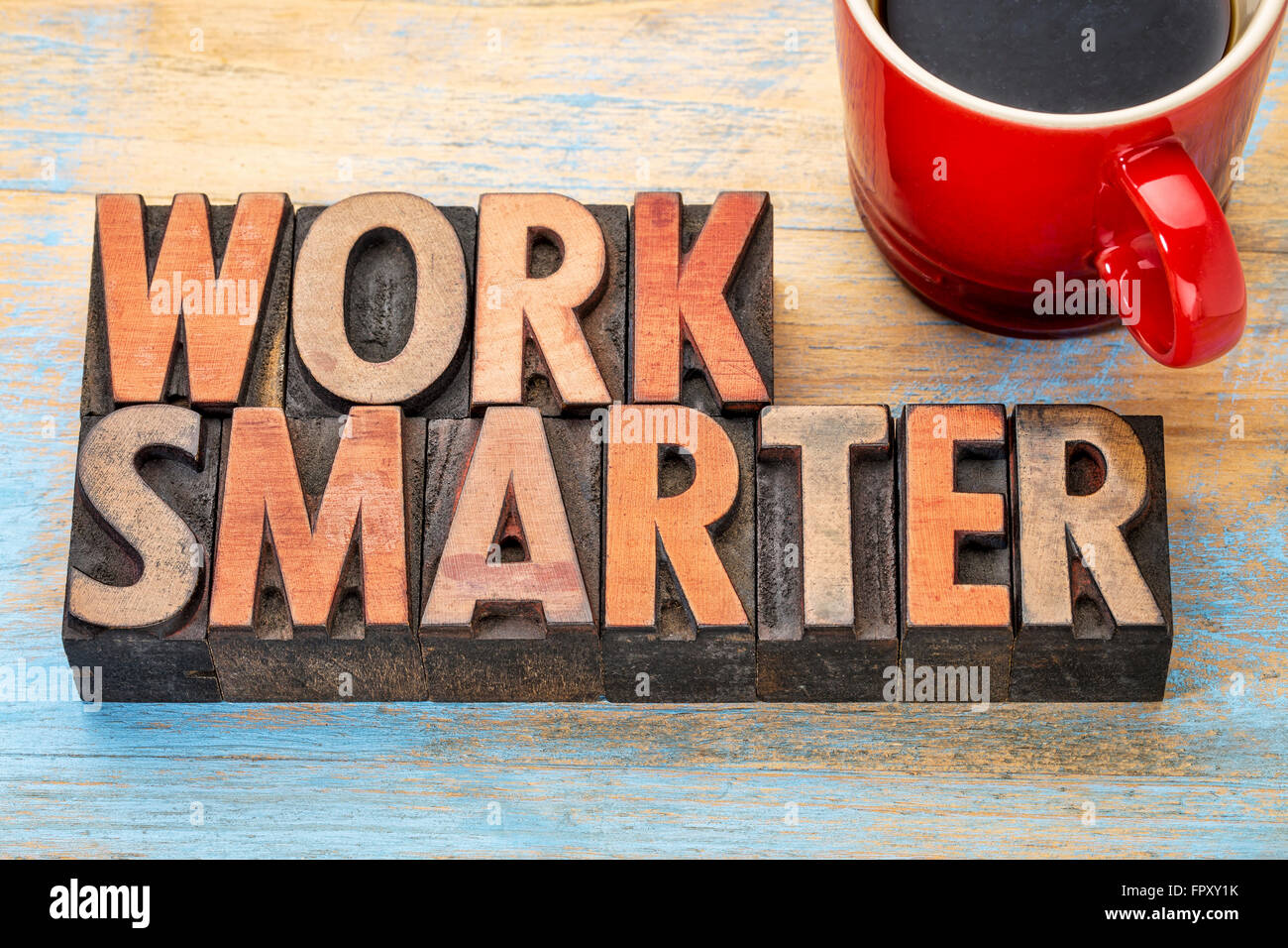 work smarter advice - words in vintage letterpress wood type blocks stained by color inks with a cup of coffee Stock Photo