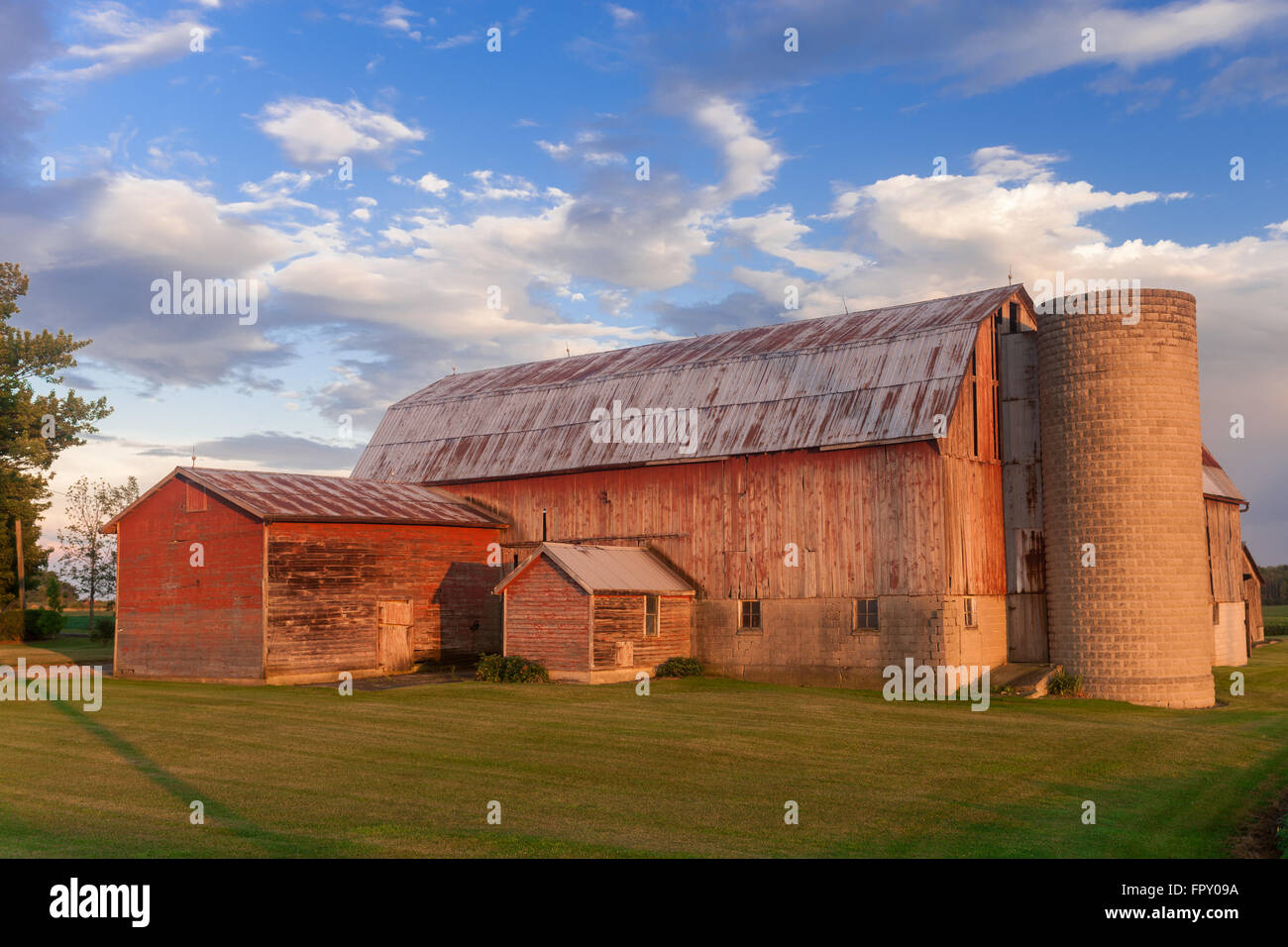 Colour landscape image showing traditional wood barn on a farm in