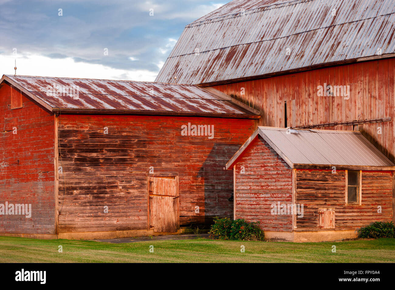 Colour landscape image showing traditional wood barn on a farm in