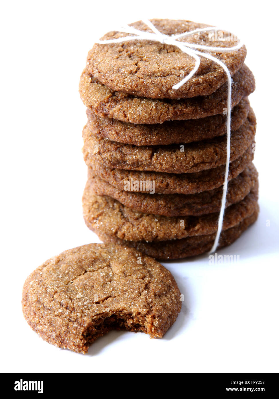 Stack of homemade ginger cookies, tied with twine and isolated on white background. Stock Photo