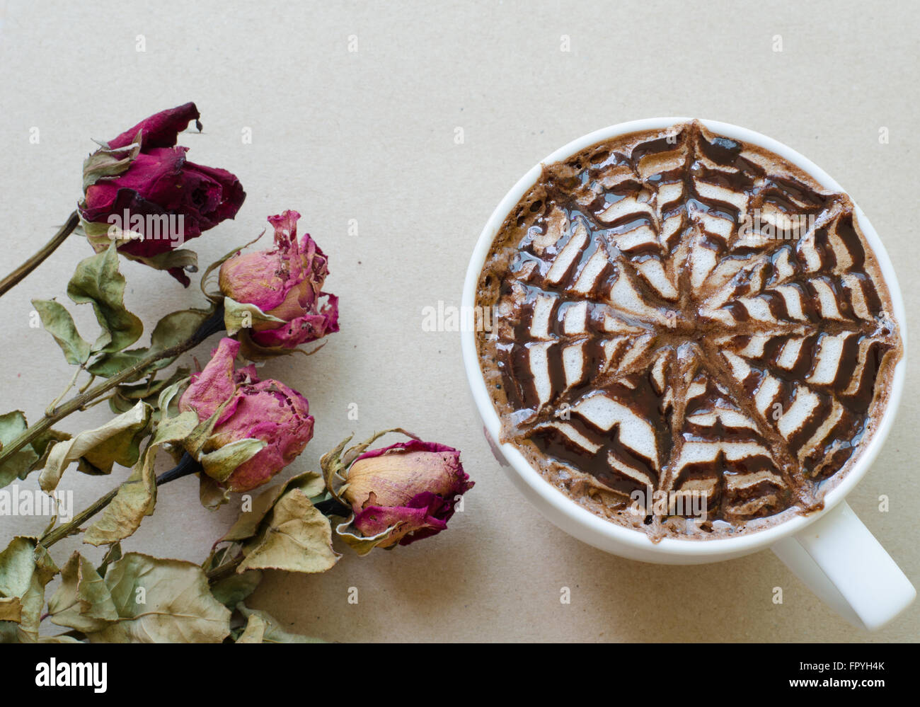 coffee with latte art and wither rose Stock Photo