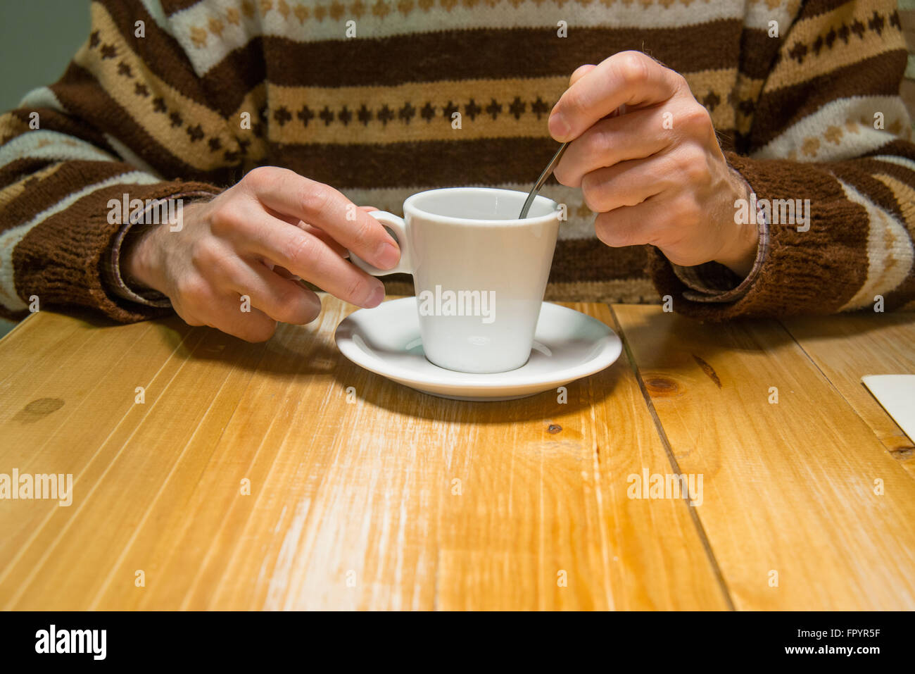 Man's hand having a cup of coffee. Close view. Stock Photo