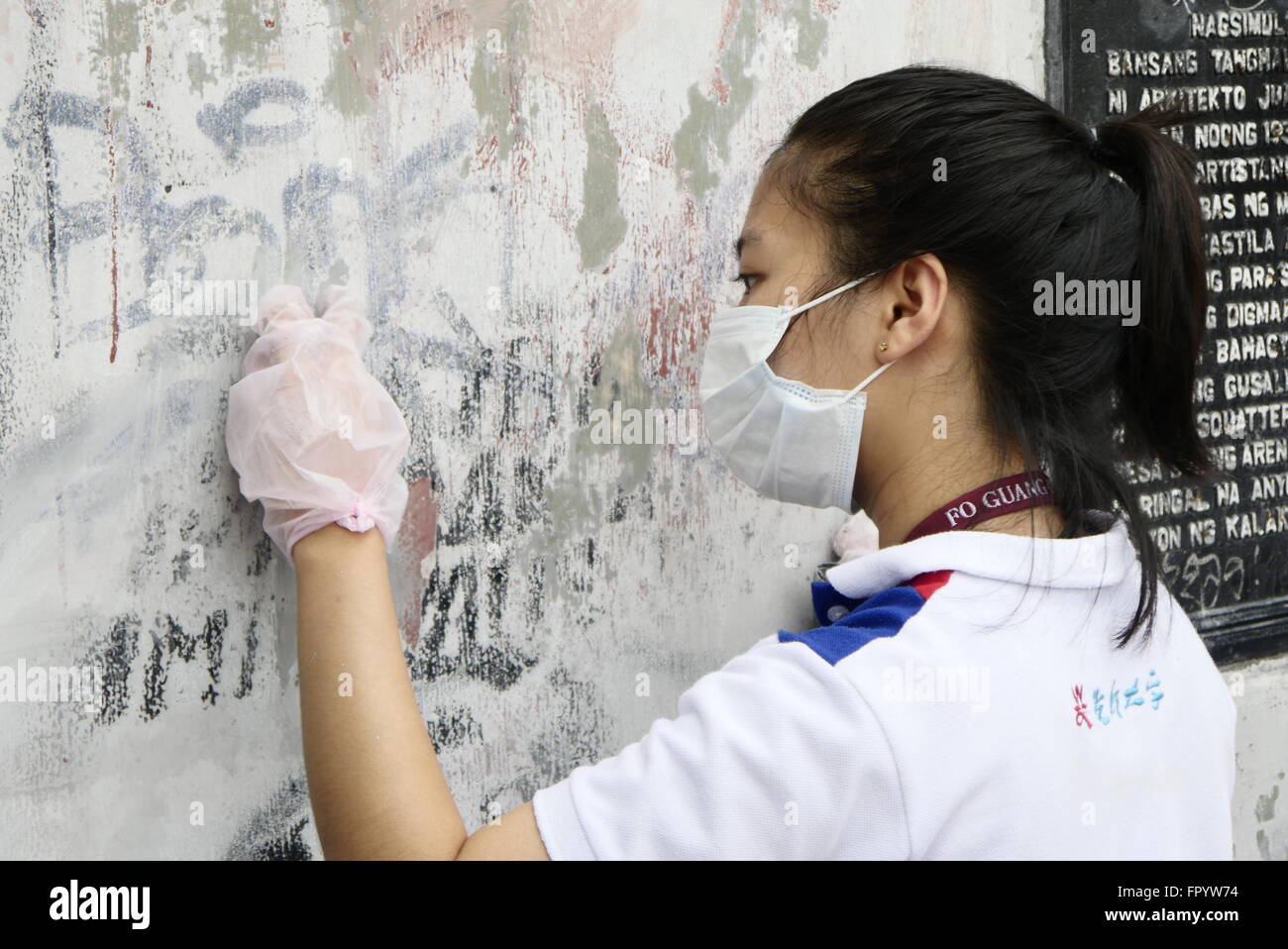 A volunteer desperately try to brush off marks on this wall. A clean-up drive for the abandoned Metropolitan Theater was launched since December. This is in an effort to restore one of the most historical theatrical site. Many veteran celebrities today became popular in this theater hosting their shows. It was in 1990s a dispute between Government Service Insurance System (GSIS) and Manila City Hall about the development of this historical site that lead to its abandonment. It was in June of 2010 with the president Gloria Macapagal-Arroyo, at that time, and city mayor Alfredo Lim try to re-ope Stock Photo