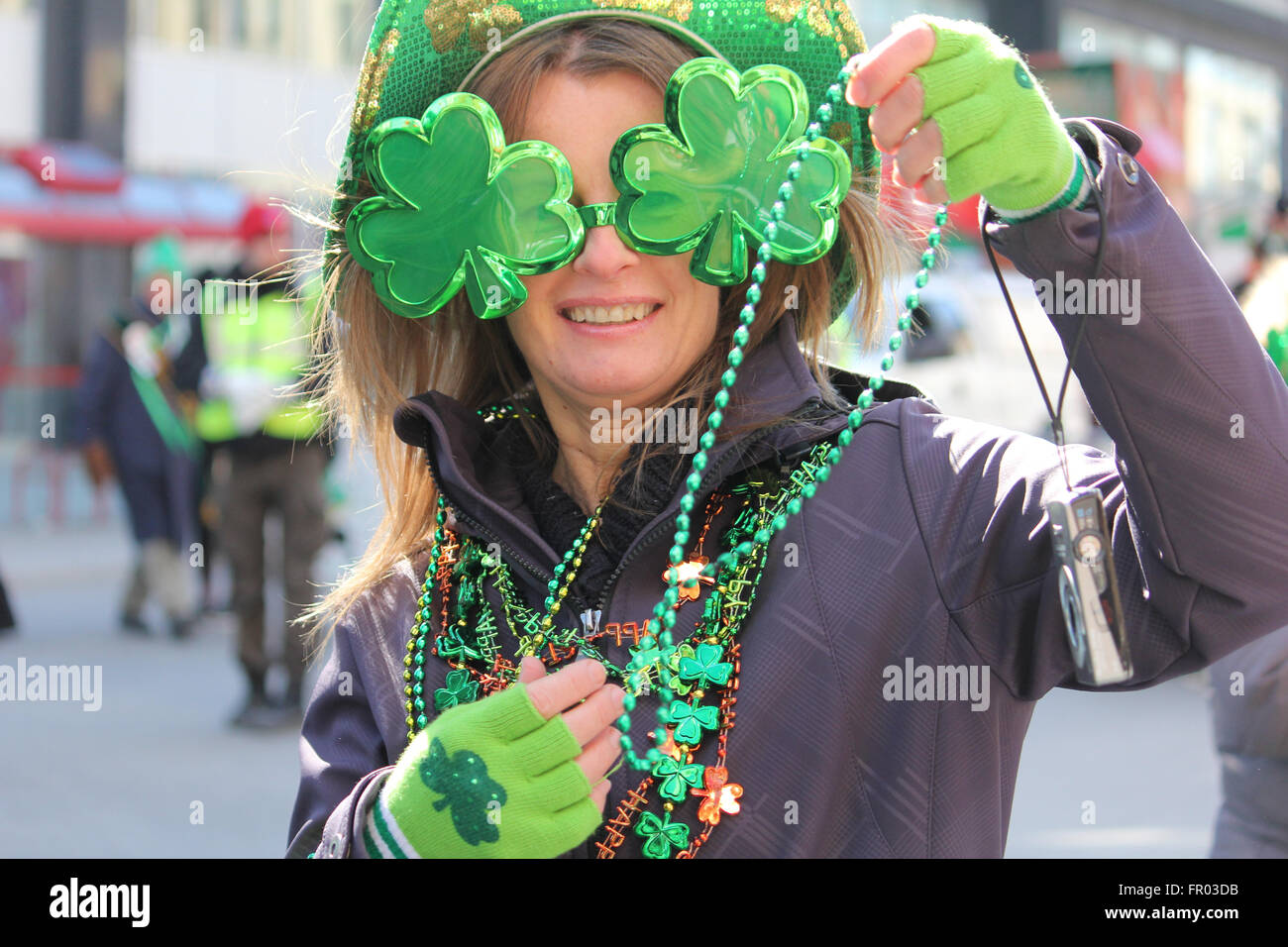 Montreal, Canada. 20th March, 2016. A lady distributing beads on St. Patrick’s Day Parade. Credit:  Ali Alshammasi/Alamy - Stock Image