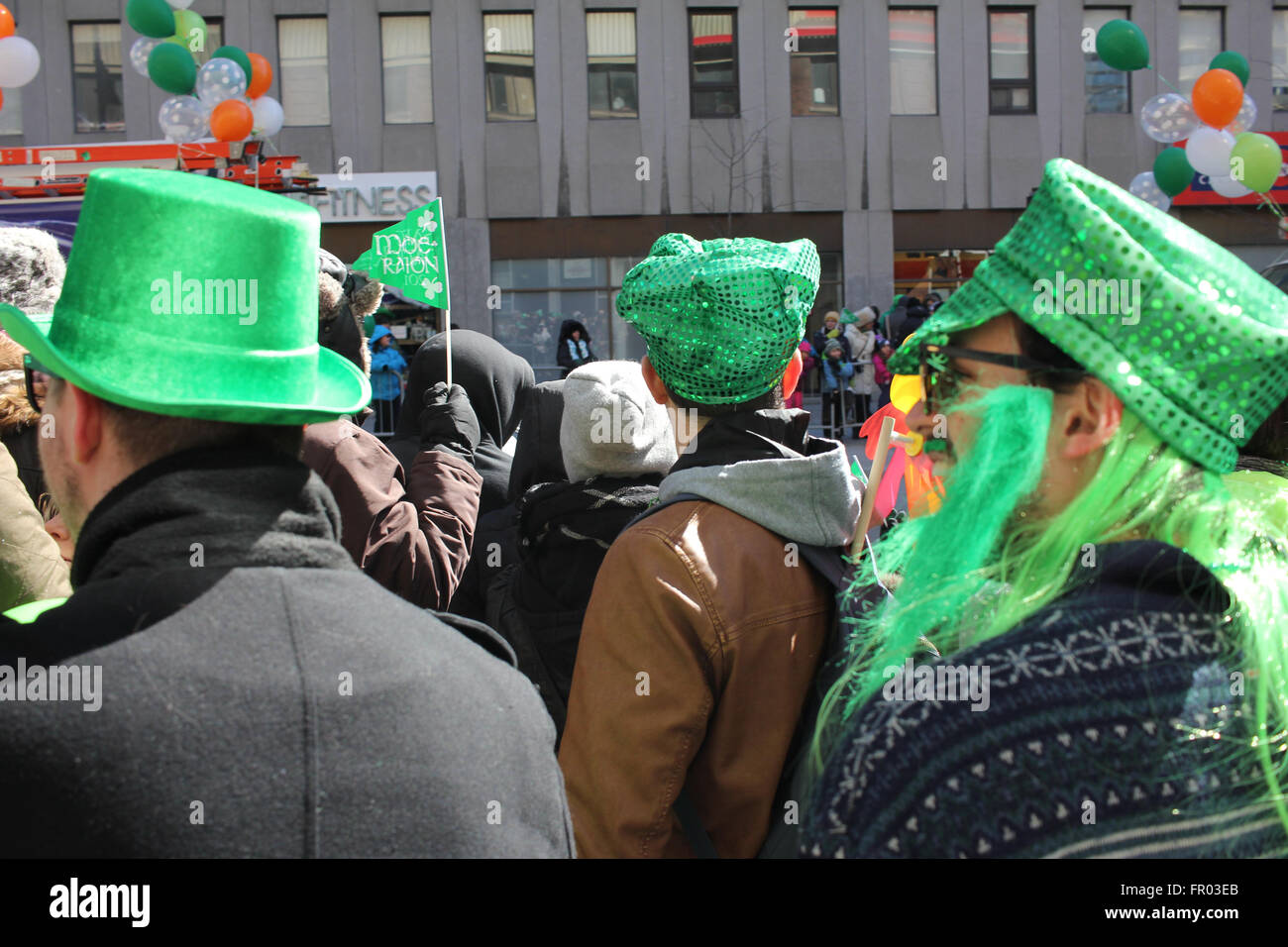 Montreal, Canada. 20th March, 2016. Crowd on the side of the street watching St. Patrick’s Day Parade. Credit:  - Stock Image
