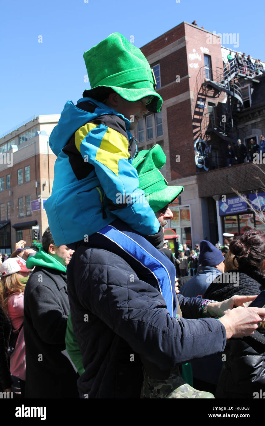 Montreal, Canada. 20th March, 2016. A kid on a man shoulder watching St. Patrick’s Day Parade. Credit:  Ali Alshammasi/Alamy - Stock Image