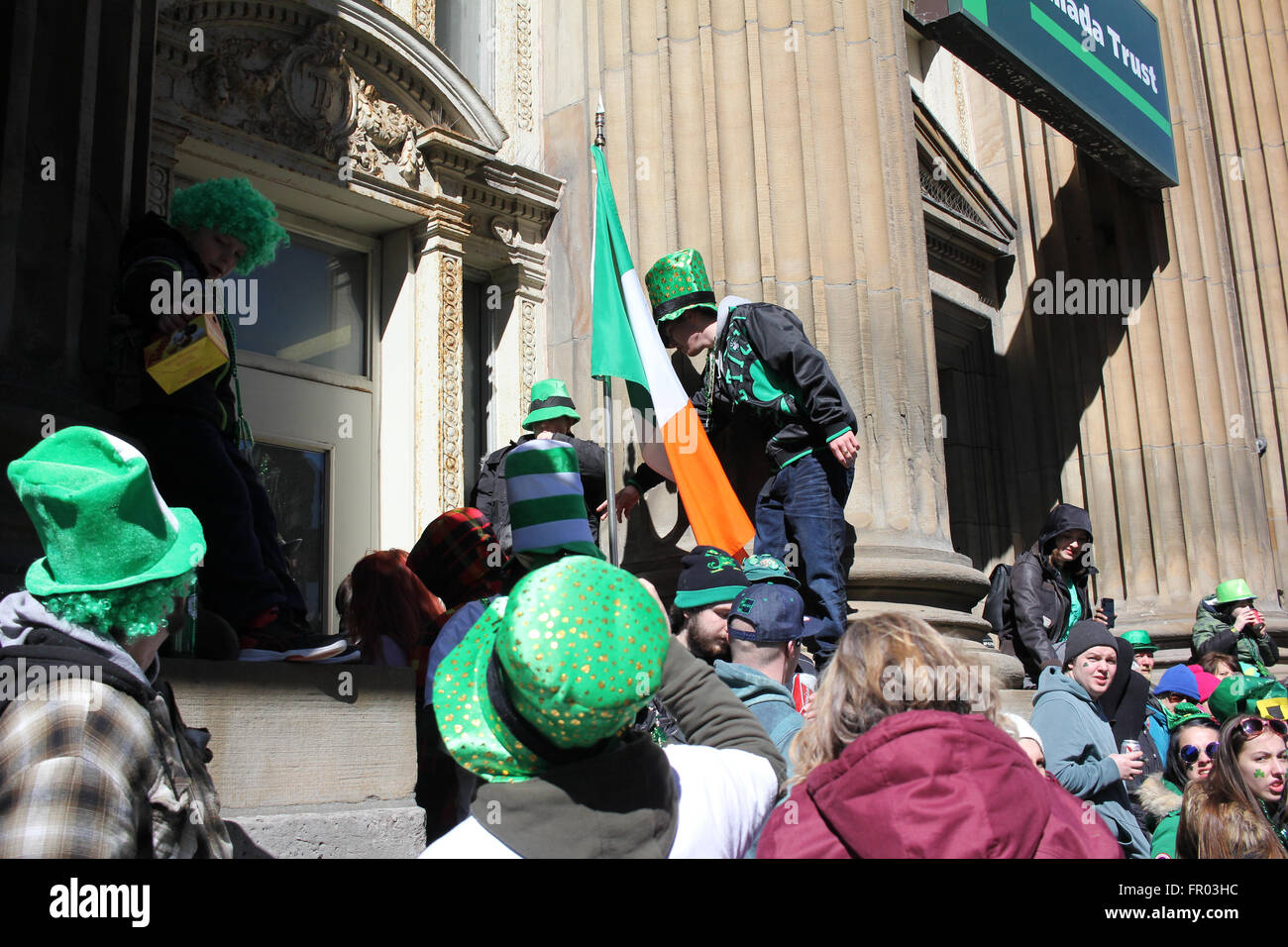 Montreal, Canada. 20th March, 2016. Crowd on the side of the street watching St. Patrick’s Day Parade. Credit:  - Stock Image