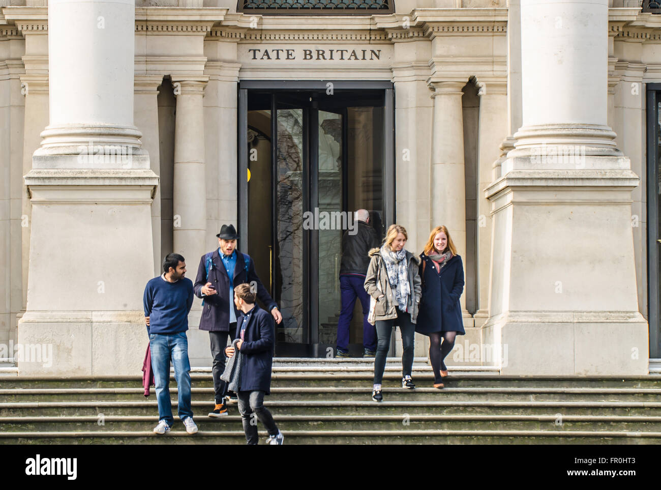 Tate Britain is an art museum on Millbank in London. It is part of the Tate network of galleries in England. Visitors leaving. People. Entrance steps Stock Photo