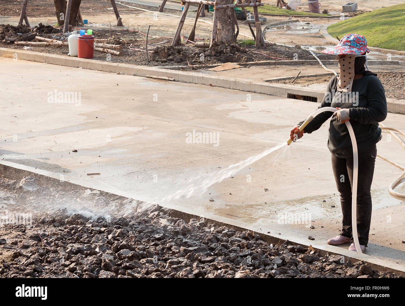labor women watering  in construction site Stock Photo