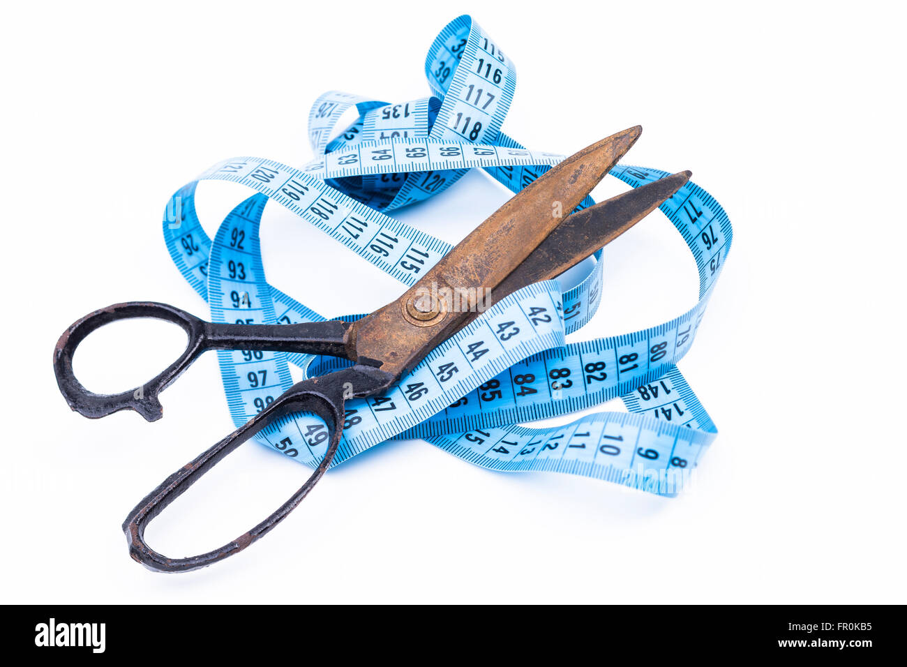 A scissors is cutting a tape measure Stock Photo Alamy