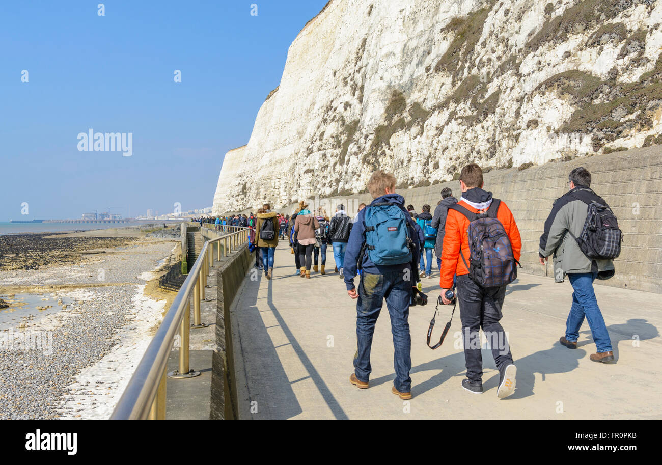 Students walking along by the white cliffs at Rottingdean, East Sussex, England, UK. Stock Photo