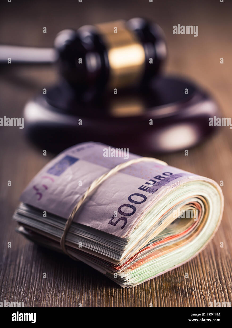 Judge's hammer gavel. Justice and euro money. Euro currency. Court gavel and rolled Euro banknotes. Representation of corruption Stock Photo