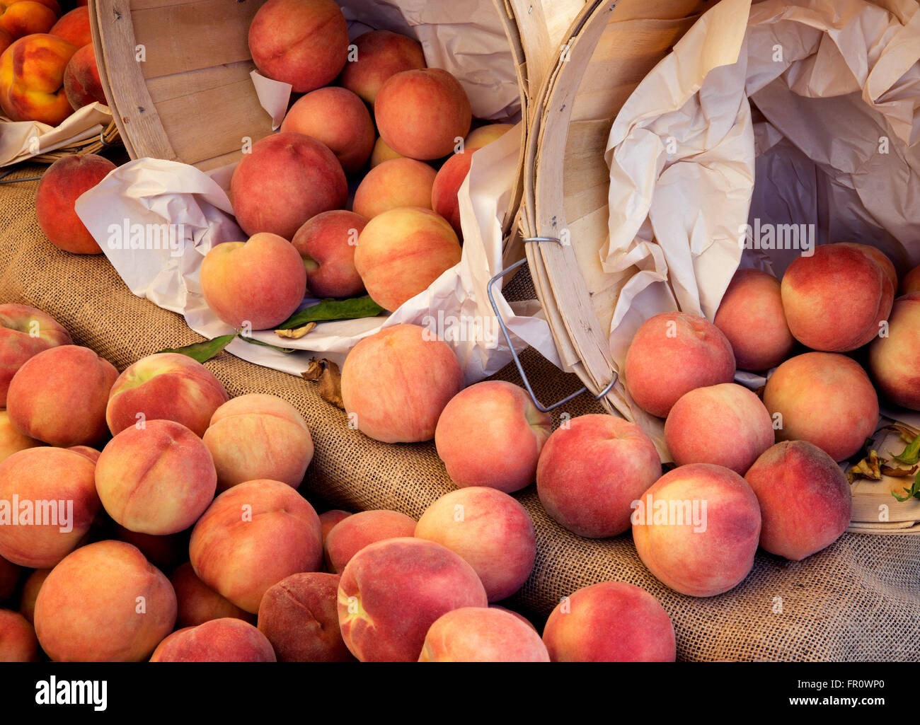 Peaches and baskets at a farmers market. Los Angeles, California Stock Photo